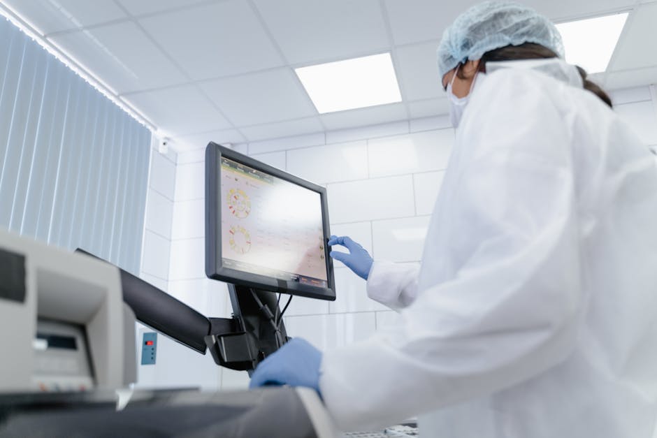 Researcher reviewing health data on a screen in a lab, illustrating AI-assisted clinical-trial monitoring.