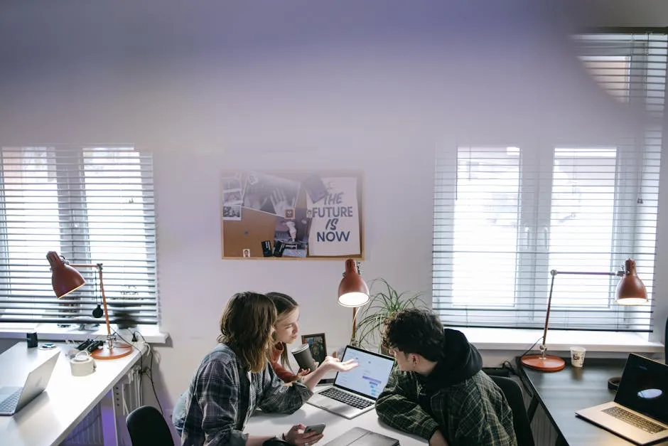 Team collaborating around a laptop with a project workspace on screen, illustrating workplace AI agents.
