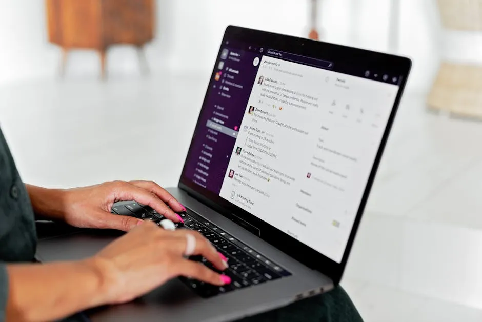 Person messaging on a laptop chat app, illustrating an AI assistant working inside team chat tools.