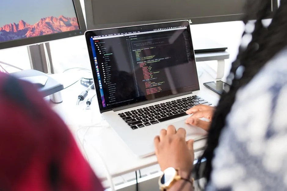 Engineer working on infrastructure code at a multi-screen desk, illustrating a major DevOps platform upgrade.