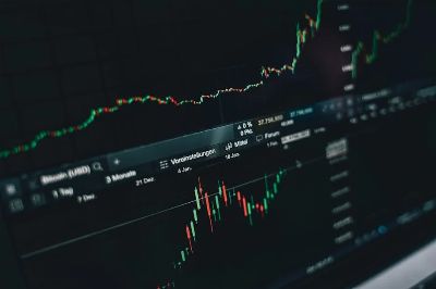 Close-up of a digital market analysis display showing Bitcoin and cryptocurrency price trends.