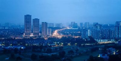A serene view of Kuala Lumpur skyline during blue hour, showcasing high-rise buildings and city lights.