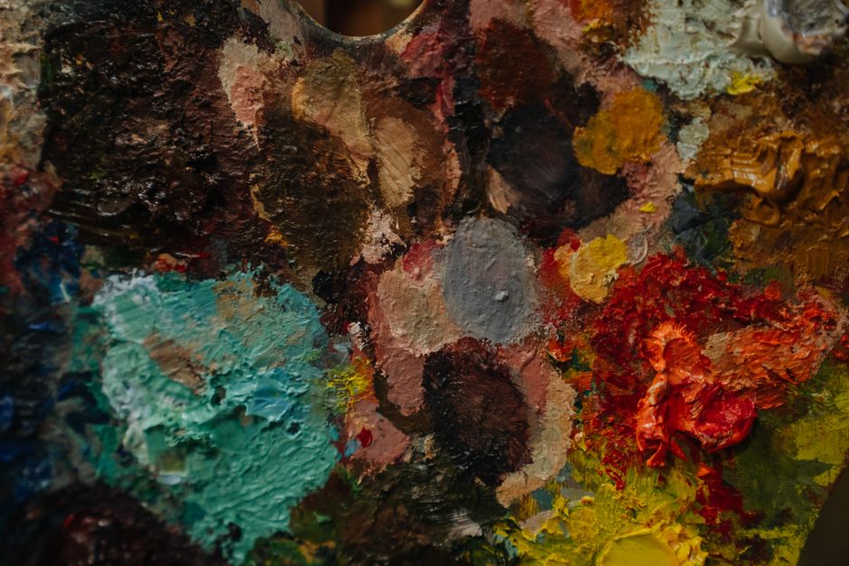 An artist palette thick with mixed paint — five AI image generators, five different licences