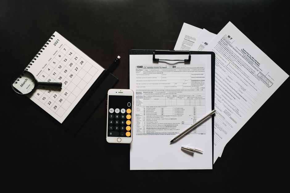 Calculator and tax paperwork — working out a monthly PCB deduction