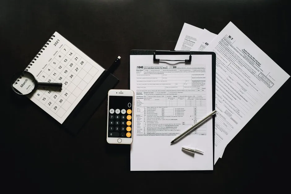 Calculator and tax paperwork — working out a monthly PCB deduction