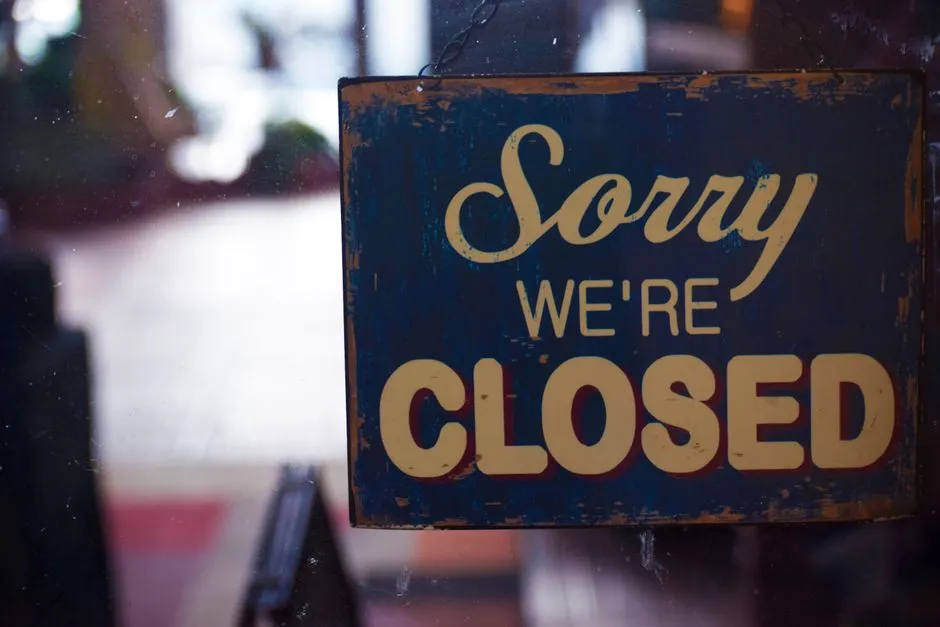 A weathered enamel 'Sorry We're Closed' sign hanging inside a shop door — illustrative of a customer channel going quiet, which is what an unremoved chat widget does on 5 October.