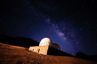 Stunning view of the Milky Way galaxy above a desert observatory under a starry night.