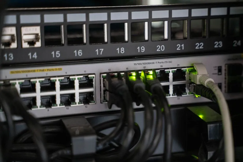 A rack-mounted network switch with lit ports and patch cabling, the kind of load a flexibility contract governs