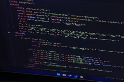 High-resolution close-up of HTML code displayed on a computer screen, perfect for technology themes.