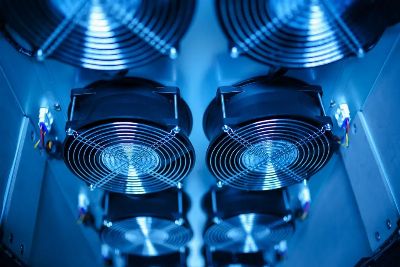 Close-up of cooling fans in a server room, showcasing technology and efficiency.