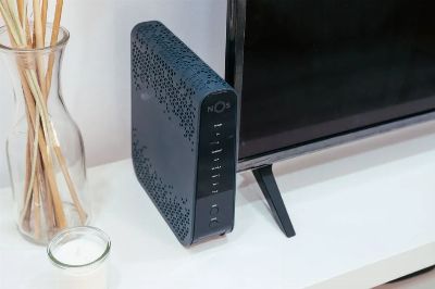 A sleek home technology setup featuring a router, glass decoration, and television.
