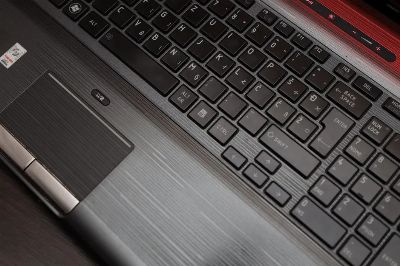 Detailed top view of a laptop keyboard and touchpad, ideal for technology themes.