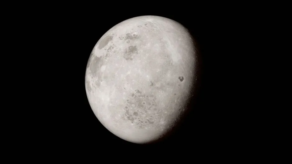 A gibbous Moon photographed against black sky, its cratered surface picked out along the terminator — illustrative; the impact site described here is not visible at this scale.
