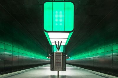 Vivid green lights illuminate the futuristic design of a subway station in Hamburg.
