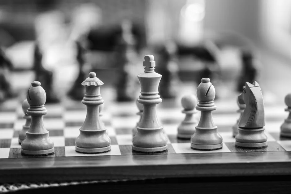 Chess pieces arranged on a board in black and white, illustrating a report on a chip supply deal structured around equity warrants.
