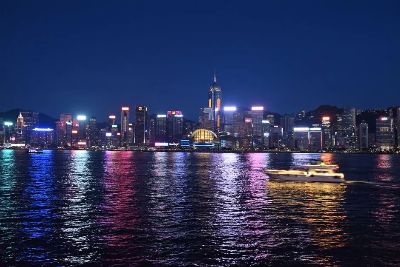 A stunning night view of Hong Kong's illuminated skyline reflecting on Victoria Harbour.
