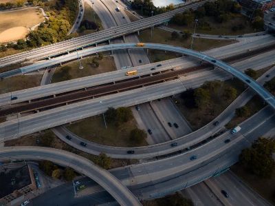 Intricate aerial view of a busy multi-level highway interchange in an urban area.