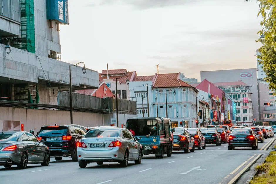 Cars queued along a Singapore street lined with shophouses