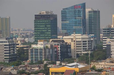 Aerial view of Jakarta's urban skyline showcasing modern skyscrapers and bustling city life.