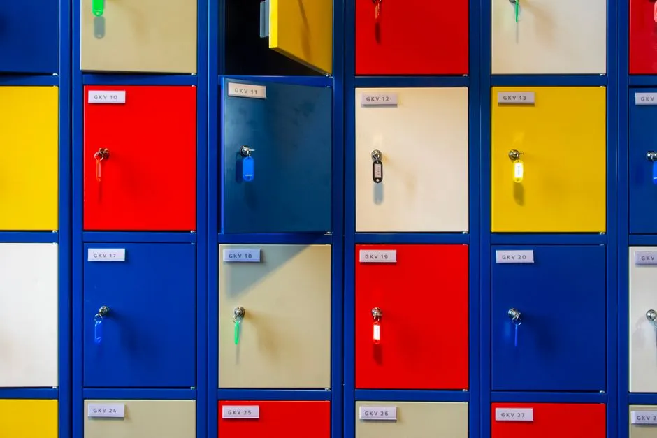 Rows of brightly coloured school lockers with keys in the doors, illustrating a report on ChatGPT for Teens and age prediction.