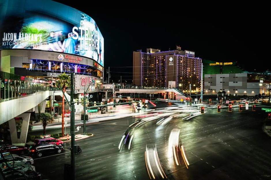 Traffic light trails along the Las Vegas Strip at night, illustrating a report on Nevada approving commercial robotaxi permits in Clark County.