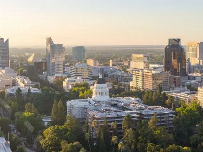 Aerial view of Sacramento cityscape featuring the California State Capitol at sunset.