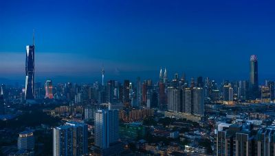 Discover the vibrant Kuala Lumpur skyline featuring iconic landmarks in the evening glow.