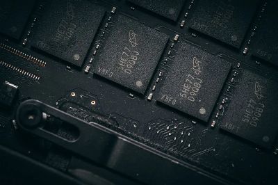 Detailed shot of microchips on a circuit board, showcasing electronic technology and precision engineering.