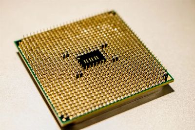 Detailed close-up of a golden microprocessor chip, ideal for technology concepts.