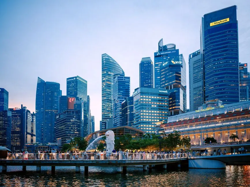 Singapore's Raffles Place financial district behind the Merlion, the area where Anthropic has opened its office