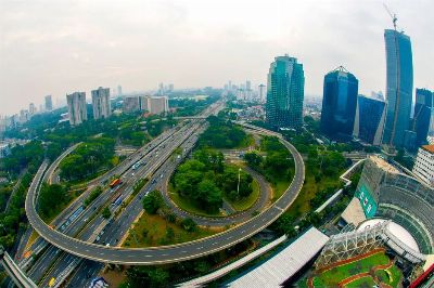 Dynamic aerial shot of Jakarta's skyline showcasing modern skyscrapers and busy highways.