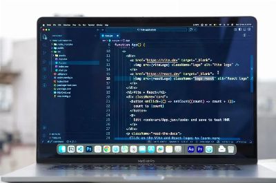 Laptop with code editor open on a rooftop, showcasing remote web development and modern work flexibility.