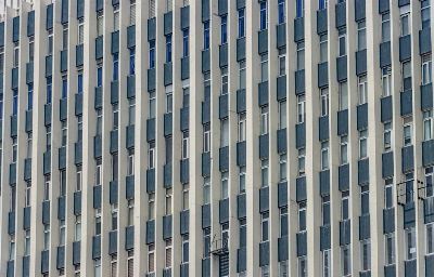 Close-up of a modern building facade with vertical symmetry in New Delhi, showcasing architectural aesthetics.