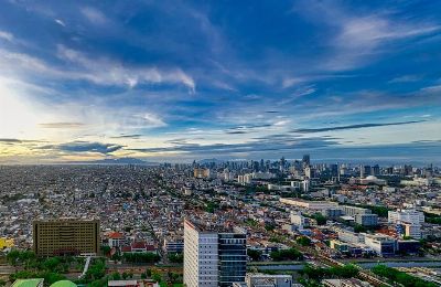 Stunning aerial view of Jakarta's cityscape at dusk, capturing its modern skyline and urban sprawl.