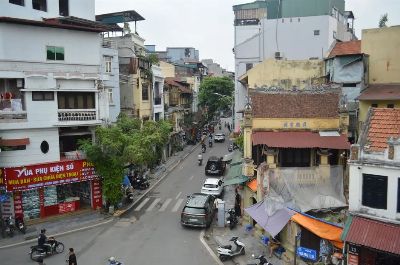 A busy street in Hanoi, Vietnam, showcasing local architecture and city life.