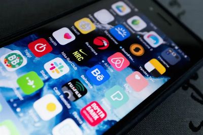 Detailed view of smartphone displaying multiple app icons on screen, highlighting technology use.