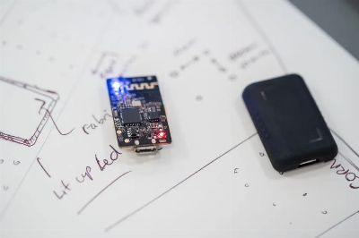 Close-up of a microprocessor and circuit board placed on technical design sketches.