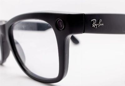 Detailed close-up shot of black smart glasses featuring a built-in camera, highlighting modern technology and design.