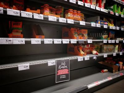Half empty shelves with assorted products in jars and containers in supermarket during quarantine