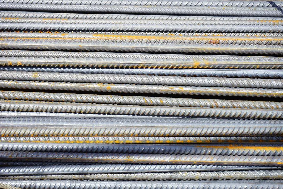 Rows of ribbed steel reinforcing bars stacked side by side