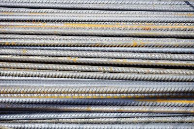 Close-up of stacked rusty steel reinforcing bars used in construction.