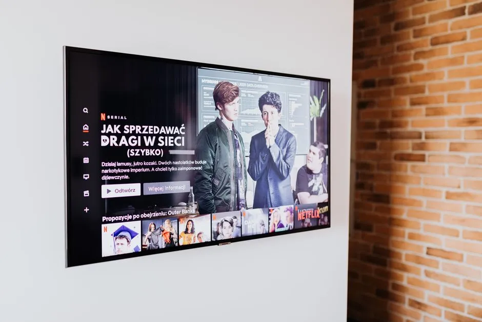A wall-mounted television showing a streaming app menu