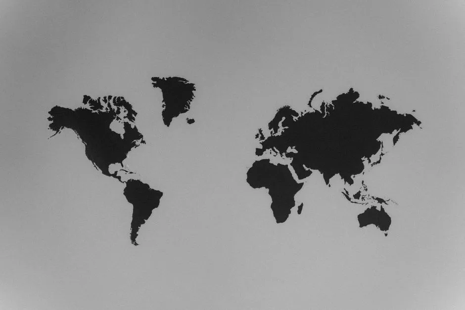 A minimalist black silhouette of the world's continents on a plain grey background