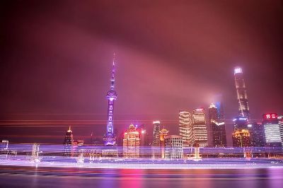 Dazzling night view of Shanghai's skyline featuring the Oriental Pearl Tower and luminous skyscrapers.