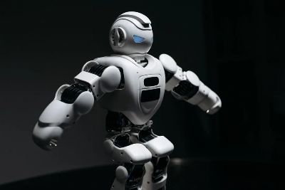 Close-up of a futuristic humanoid robot under dramatic lighting in dark ambiance.