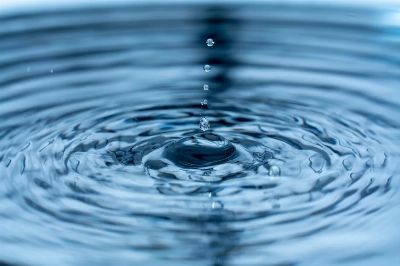 A mesmerizing close-up of water droplets and ripples, capturing dynamic motion and beauty.