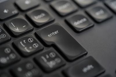 Detailed close-up photograph of a black keyboard's enter key, showing precision and modern design.