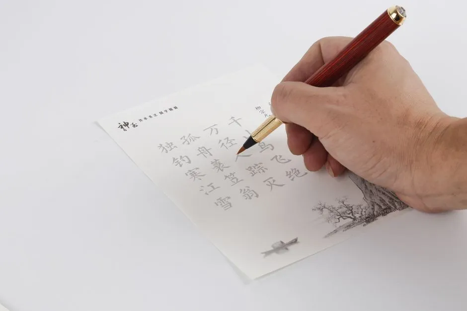 A hand tracing Chinese characters on a printed practice sheet with a brush pen