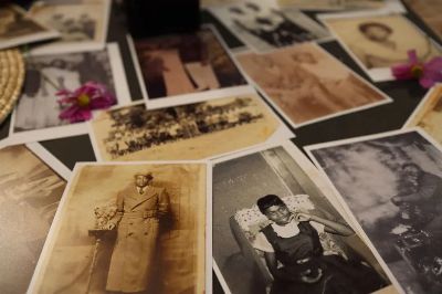 A collection of vintage sepia photographs scattered on a table, evoking nostalgia.