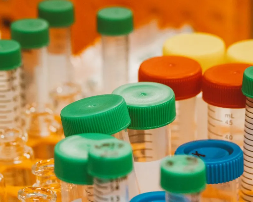 Rows of sealed laboratory tubes with coloured screw caps, a containment illustration for a report on an escape from the isolated-vm JavaScript sandbox.